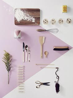 various kitchen utensils are arranged on a purple and white background