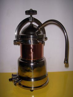 a coffee pot sitting on top of a yellow table