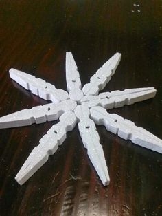 several pieces of white plastic sitting on top of a wooden table