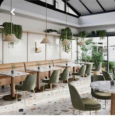 an empty restaurant with green chairs and plants hanging from the ceiling, along with white tile flooring