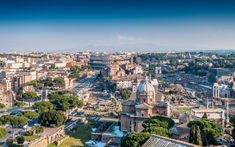 an aerial view of the city of rome, with roman architecture in the foreground