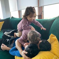 a man and two children are sitting on a couch