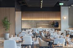 an empty restaurant with many tables and chairs set up for dinner or other mealtime