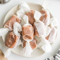 several pieces of food on a white plate with napkins around it and a wooden spoon