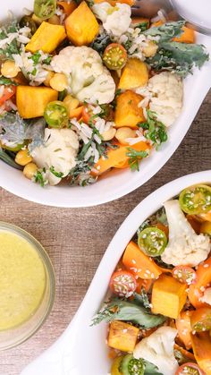 two white bowls filled with vegetables next to a yellow liquid