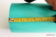 a person measuring the length of a roll of tape