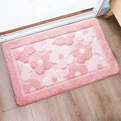 a pink rug with hearts and flowers is on the floor next to a door way