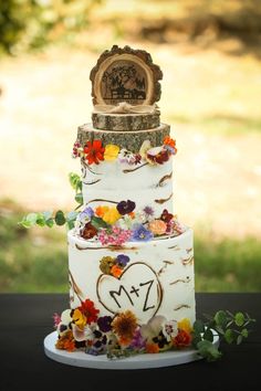 a wedding cake decorated with flowers and an image