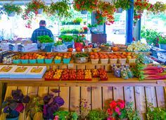 an outdoor market with fruits and vegetables on display