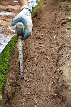 a person is using a measuring tool to measure the soil