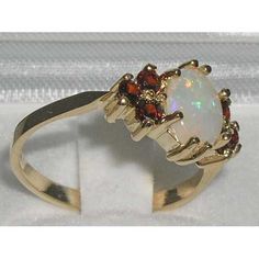 Elegant 14K Yellow Gold Oval Natural Colorful Opal with Garnet Accent Solitaire Style Ring, English Oval Cluster Ring With Gemstone Accents For Gift, Oval Cluster Ring With Gemstone Accents, Oval Yellow Gold Cluster Ring With Gemstone Accents, White Oval Ruby Ring, Oval White Ruby Ring, Oval Multi-stone Yellow Gold Birthstone Ring, Oval White Ruby Gemstone Ring, Gold Oval Multi-stone Birthstone Ring, Classic Oval Multi-stone Birthstone Ring