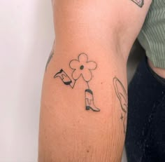 a person with a flower tattoo on their arm