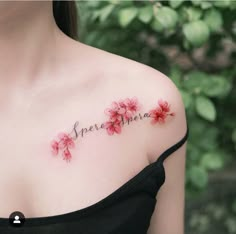 a woman with pink flowers on her chest and the words spell spelled in cursive writing