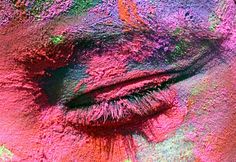 a close up shot of the eye of a woman's pink and green makeup