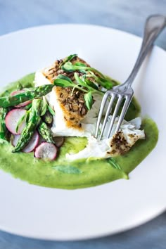 a white plate topped with food and a fork