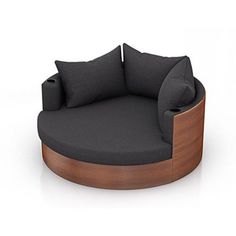 a round couch with two pillows on the back and one seat upholstered to the side