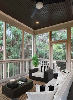 a screened porch with couches and tables on it