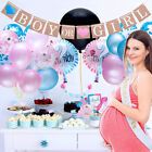 a pregnant woman standing in front of a table with balloons and cupcakes on it