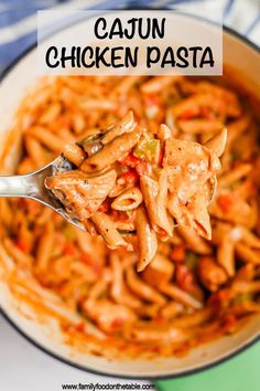 a spoon full of chicken pasta with the words cajun chicken pasta ready in 30 minutes