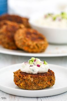 two white plates with food on them, one is carrot cakes and the other has sour cream