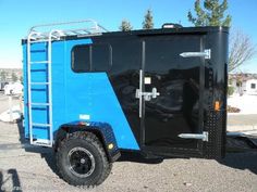 a blue and black trailer parked in a parking lot