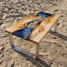 a wooden table sitting on top of a sandy beach