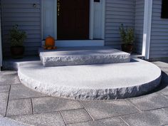 two steps leading up to the front door of a house