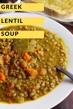 a white plate topped with lentil soup next to two plates filled with bread and vegetables