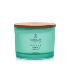 the body shop balance and harmony candle in green glass with wooden lid on white background