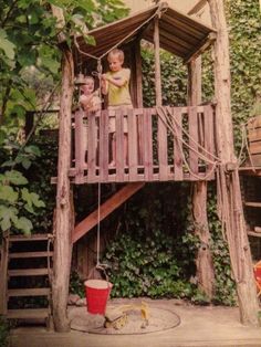 an old photo of two children in a tree house