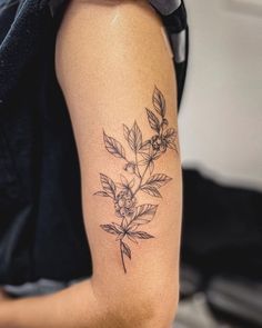 a woman with a flower tattoo on her arm