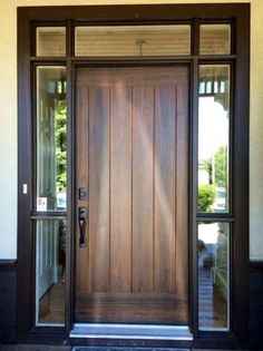 a wooden door with glass panels on the front and side doors are open to let in light