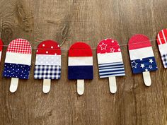 several popsicles are lined up on a string with the colors of the american flag