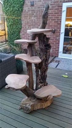 a tree stump with some kind of thing on it's back deck in front of a house