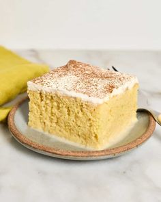 a piece of cake sitting on top of a plate next to a banana and spoon