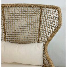 a wicker chair with a white pillow on it