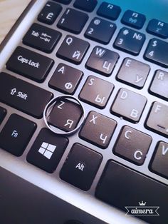 a close up of a computer keyboard with a magnifying glass in the middle