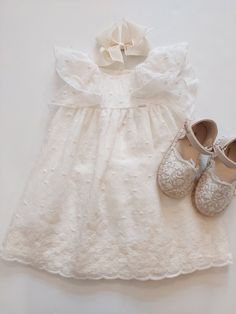 Elevate your baby girl's summer wardrobe with this stunning off-white Mayoral dress. The knee-length dress is made with embroidered lace fabric and features flutter sleeves, making it perfect for your little one's playtime or a dressy occasion.  This NWT dress is suitable for babies aged 9 months, making it a perfect addition to their wardrobe for the warmer months. The dress is ideal for a variety of events, and the embroidered lace fabric adds a touch of elegance that will make your baby girl stand out. cotton blend dress, 100% cotton lining. Lace Dress With Ruffles And Flutter Sleeves, Summer Cotton Lace Dress With Ruffles, Spring Baptism Dress With Broderie Anglaise, Cream Ruffled Lace Dress For Baptism, Cream Lace Ruffle Dress For Baptism, White Lace Dress For Baptism In Spring, White Lace Dress For Spring Baptism, Off White Lace Dress With Ruffles, Summer Baptism Dress In Cream For Dress-up Occasions