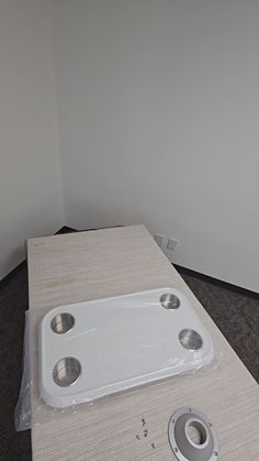 a white sink sitting on top of a table next to a toilet paper dispenser