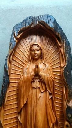 a wooden statue of the virgin mary on display