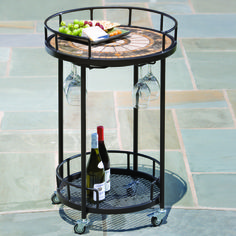 a wine bottle and two glasses on a table with a tray full of wine bottles