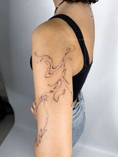 a woman with a tattoo on her arm