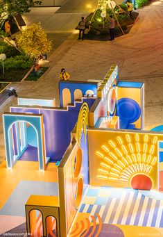 an aerial view of a brightly lit play area with children's slides and toys