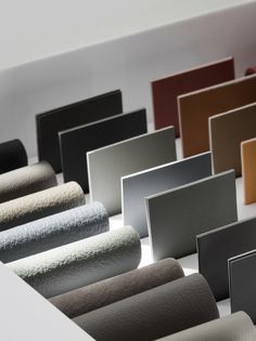 some different colors of wall paper on a white surface with black, brown, beige and grey trims