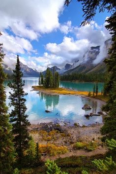 a lake surrounded by pine trees and mountains