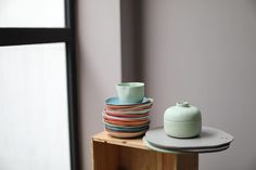 a stack of plates sitting on top of a wooden table