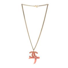 This is an authentic CHANEL Metal Enamel Velvet CC Bow Necklace in Pink. This chic necklace sits below-the-collar length and features a simple gold chain with a pink enamel Chanel CC charm outlined in gold with a small pink velvet bow. Enjoy this necklace for a bold accent of the timeless quality and style you find only from Chanel! Simple Gold Chain, Chanel Necklace, Chic Necklace, Bow Necklace, Chanel Jewelry, Pink Enamel, Velvet Bow, Pink Velvet, Necklace Gold