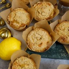 some muffins are sitting on a table next to a lemon and other food items