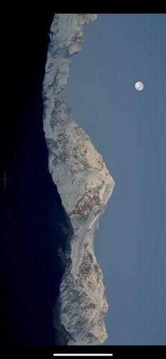 the moon shines brightly above an icy mountain