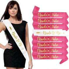 a woman wearing a black dress and pink sash with gold lettering on it, standing in front of a white background